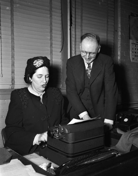 Mrs. Joseph (Betty Pruett) Farrington, former police reporter, recalls work days with Russell B. Pyre, current reporter. She was a police reporter from 1918 to 1920.