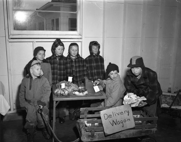 Neighborhood children from the 2700 blocks of Van Hise Avenue and Mason Street held a bake sale to raise funds toward the purchase of a replacement for Annie the elephant, who died Feb. 24, 1948, at the Vilas Park Zoo (Henry Vilas Zoo). Shown at the bake sale table, left to right, are Ronnie Quisling, Bennie Hofmeister, David and Dennis Pearson, Charles Radke, Billy Kaeser, and David Hofmeister.