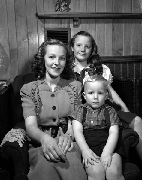 Group portrait of Mrs. Wilson (Audrey) Fahlberg and her children, Karen, 8, and Wilson Jr., 4 at their trailer home at Badger Village. Mrs. Wilson is the president of the Badger Village wives' club. Mr. Wilson is a veteran of World War II and attends the University of Wisconsin.