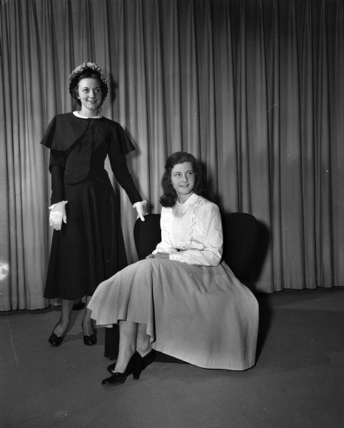 Patricia McGovern and Jane Botham model "dress up" clothes for high school girls.