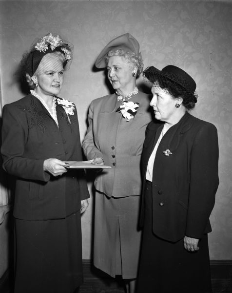 Honorary city commander of the Madison branch of the Wisconsin Division of the American Cancer society, Mrs. Oscar (Mary) Rennebohm, was given a citation by Mrs. Joseph (Bessie)? Berg, City Commander. At the right is Mrs. A.G. Mac Holz, Beaver Dam, adjutant and publicity director at a "kick off" luncheon meeting.