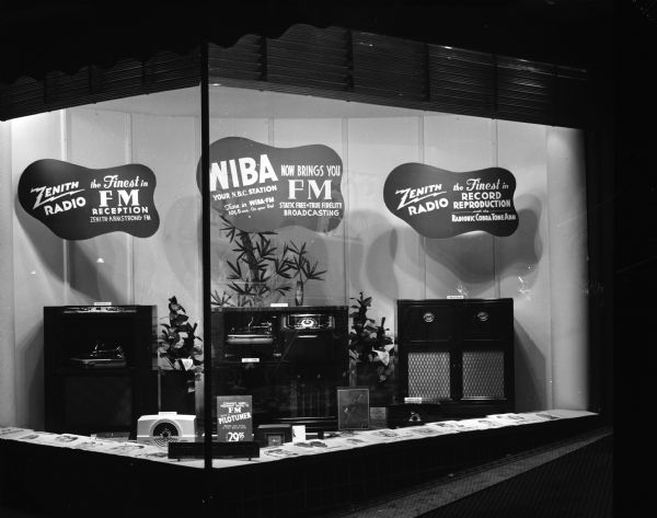 Corner window display featuring Zenith Radios and station WIBA advertising the new FM broadcasting service.