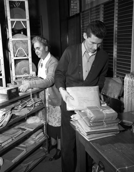 University of Wisconsin-Extension mailing department, with Mrs. May B. Shire and Craig Gunter hard at work mailing loan packages of information throughout the State.