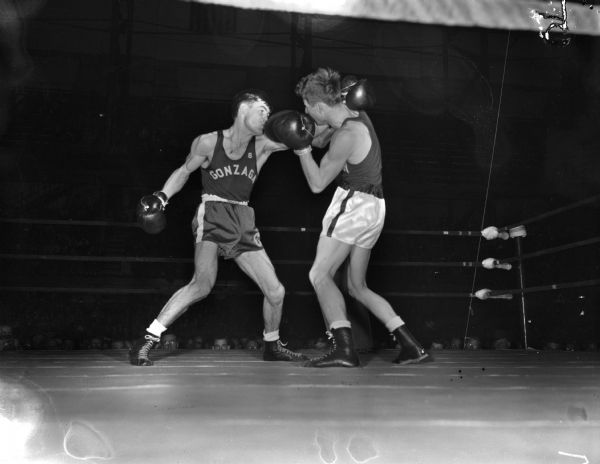 NCAA Boxing Tournament at the University of Wisconsin-Madison Field House, Bout 13, "Art Neumayer, Gonzaga, missing with a left hand in the second round and ready to try with a right hand which Steve Gremban, Wisconsin, blocked."