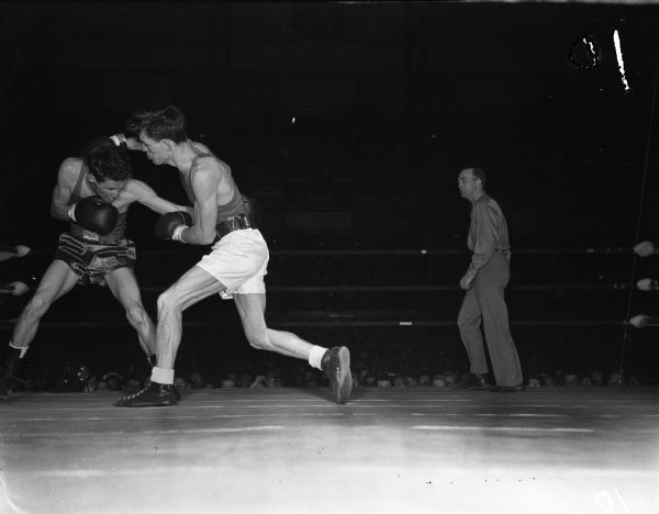 Wilbert Moss of Louisiana State came through with an upset victory. He defeated Gerald Auclair of Syracuse, a bantamweight and 1947 champion.  The two men are participating in the NCAA championship being held at the University of Wisconsin-Madison Field House.
