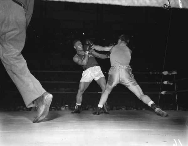Wisconsin's Calvin Vernon, an African-American, had led with a left and was blocking a left return by Idaho's Bill Diehl in the first round of their light heavyweight bout. The two men are participating in the NCAA championship being held at the University of Wisconsin-Madison Field House.