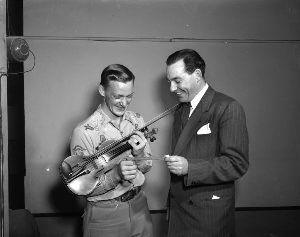 George Gilberstson, champion of the Old-Time Fiddlers' contest at the Madison Community Center, receiving his $35 prize from the Master of Ceremonies, Ralph O'Connor.
