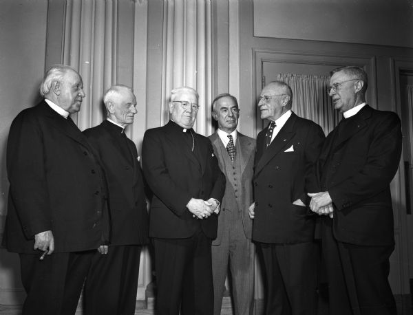 Six World War I veterans at a "Red Arrow" veterans dinner honoring Bishop William P. O'Connor who was a chaplain of Wisconsin's 32nd division in World War I. Pictured from left to right are: Rev. John B. Piette, Portage; Rev. Gustav Stearns, Milwaukee, Protestant chaplain with the division; Bishop O'Connor; Col. Carl Penner, Milwaukee, wartime commander of the 120th field artillery; Dr. William F. Lorenz, toastmaster; and Rev. George Eilers, Fond du Lac, former classmate of the bishop's.