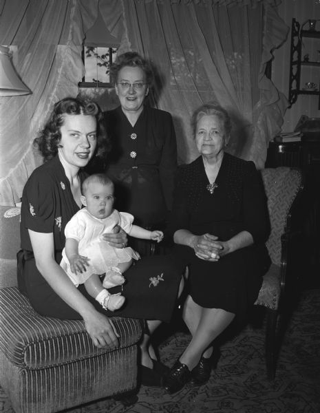 A four-generation group portrait of three women with an infant. Taken for Mrs. Bakken.