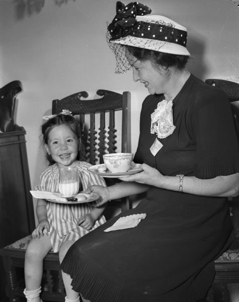 Mrs. Norman Beauchaine, president of Riverview PTA of Marshfield and daughter, Bonnie Lou, age 3, at a tea at the Governor's residence, 130 E. Gilman St., hosted by Mrs. Oscar Rennebohm.