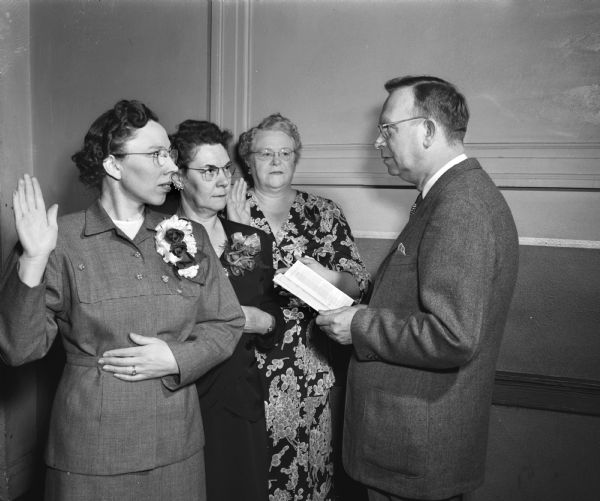Two hundred fifty delegates attend the state meeting of the Fraternal Order of Eagles Auxilliaries. Installation of new state officers was presided over by LeRoy E. Coster, past president of the Madison Aerie (far right), pictured with the new officers, left to right: Mrs. Augusta Heggestad, Madison, secretary; Mrs. Louise M. Murphy, Superior, president; and Mrs. Minnie Aller, Racine, vice-president.