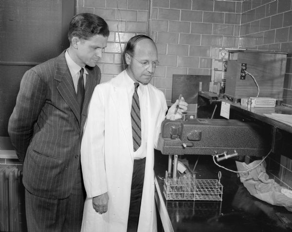 Dr. Harold P. Rusch, right, director of the McArdle Memorial Laboratory for cancer research, is shown with R.O. McLean, Madison, executive director, Wisconsin division American Cancer Society.