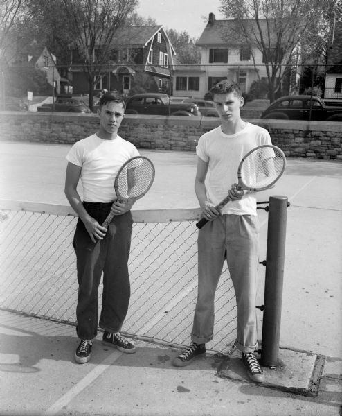 Southern Ten conference tennis singles champion Ernie Vogler, Monroe, on the right, unknown student on the left.
