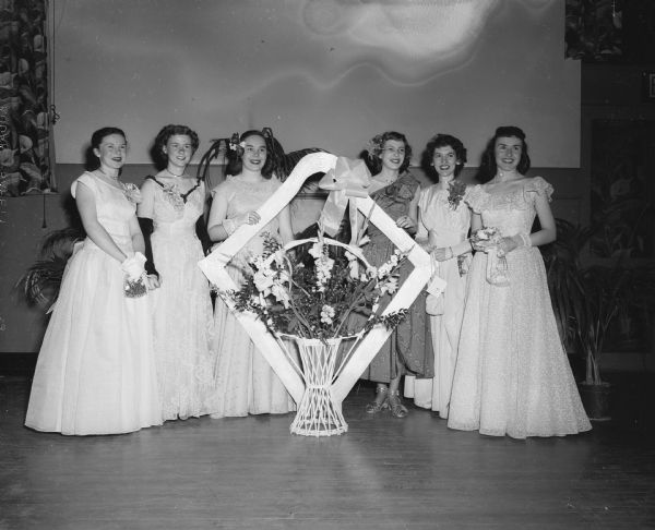 Group portrait of the six young women who served as a "court of honor" for the queen at the Edgewood Junior College spring prom. Pictured left to right: Ruth Doyle, daughter of Mr. and Mrs. Stephen Doyle, Highland; Mary Lang, daughter of Mr. and Mrs. John Lang, 220 Grand Avenue; Eileen McCullough, daughter of Mr. and Mrs. L.J. McCullough, Janesville; Jean Podell, daughter of the Arthur Podells, 110 North Sixth Street; Patricia Dean, daughter of the Herbert R. Deans of Hartland, and Kathryn Ford, daughter of Mr. and Mrs. Arthur T. Ford, Janesville.