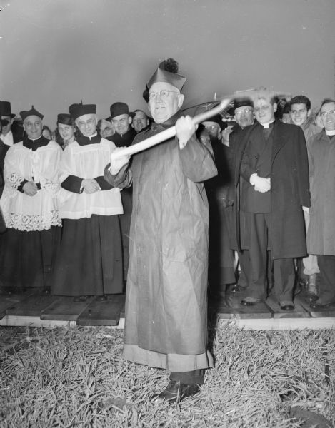 Bishop William P. O'Connor of the Madison Diocese is shown removing the first shovel of dirt at the ground-breaking of the Queen of Apostles Seminary being erected at the site of the Friday Dairy Farm on County Highway BB, 5810 Cottage Grove Road.