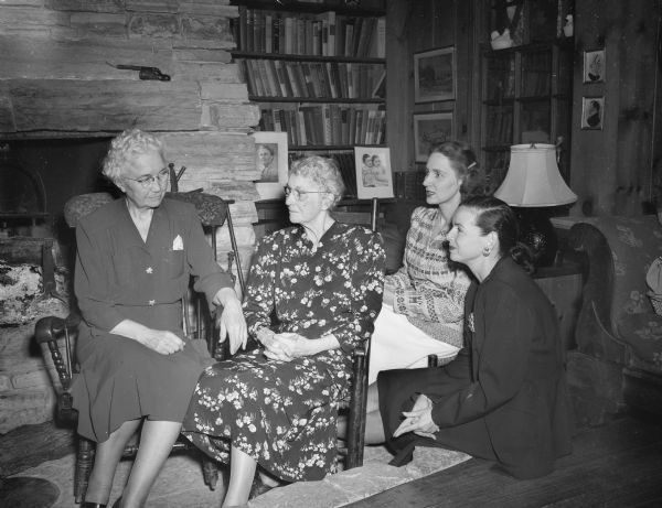 Alumnae of the Delta Delta Delta sorority gathered at the home of Professor and Mrs. Ray and Theo Owen, 5805 Winnequah Road, Frost Woods, Monona, for a 50th anniversary reunion. Pictured left to right: Mrs. Florence Allen and Mrs. Herbert H. Thomas, Madison, charter members of the Wisconsin chapter, with younger alumna, Mrs. Harry L. Skiles, vice-president of the Tri-Delt alliance, and Mrs. Joseph C. Dean, both of Madison.