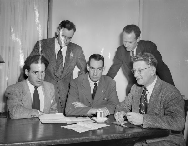 Members of the University of Wisconsin dance committee making arrangements for the spring sem-formal dance. Left to right:  Professor Werner Roehm; Robert Finley; Professor Arathu H. Robinson; Professor Edgar Lacy; and Vidkunn Ulriksson, chairman.