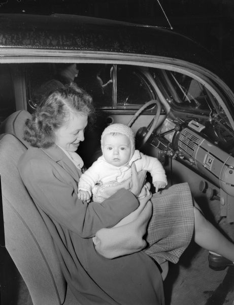 Mrs. Violet (Warren) Jollymore and baby Jock in car. Warren was a reporter for the Wisconsin Union Theater. Jock Warren Jollymore was born Sept. 20, 1947.