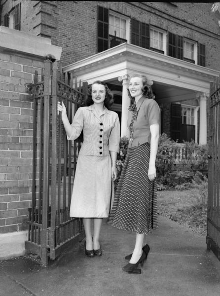 Alpha Phi sorority, 28 Langdon Street, was the site of a garden party for all sorority women on the University of Wisconsin-Madison campus. Left to right: Alpha Phi pledge Patricia Clancy, East Troy and Pattie Neilson, Milwaukee, Gamma Phi Beta sorority.