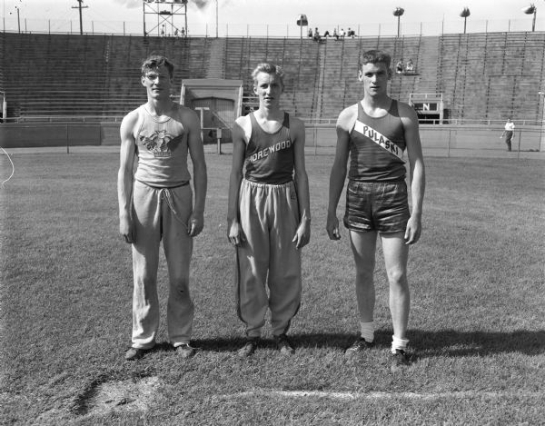 Three athletes who tied for the class A high jump event at the state high school track meet at Camp Randall Stadium. Left to right: Dick Kellman, Madison West; Jerry Kenkel, Shorewood; and Al Cherne, Milwaukee Pulaski.