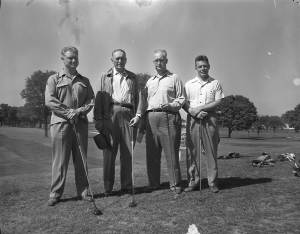 Four participants in the Western Conference "Big 9" Officials Golf Tournament at Maple Bluff Country Club. Left to right: Purdue Athletic Director, Guy Mackey; Conference Athletic Commissoner, Kenneth L. Wilson; Purdue Business Manager, C.S. Doan; and Iowa Athletic Director, Paul Brechler.