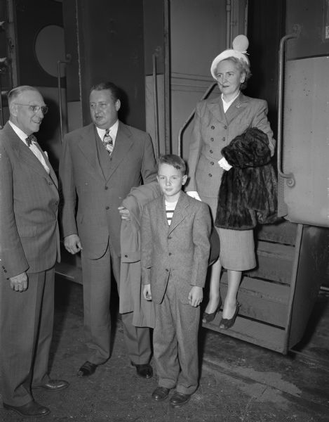 Wisconsin's Chairman of the State Highway Commission, James R. Law (left), greeting Secretary of the Interior, Julius A. Krug and his wife and son. They are visiting Madison for the Wisconsin Centennial celebration.