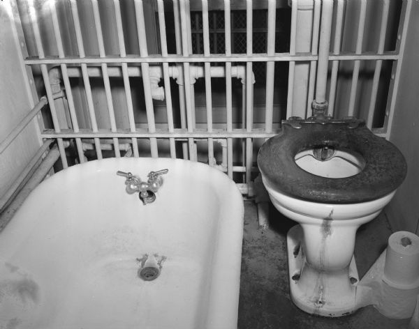 Dane County Jail woman's bathroom, with bathtub and toilet, showing unfit conditions.