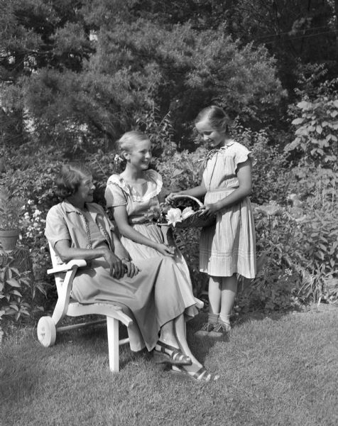Group portrait in the garden of J. Clayton and Grace Howdle, 3456 Crestwood Dr., of Grace Howdle and her daughters Sally, 12 and Mary, 9.