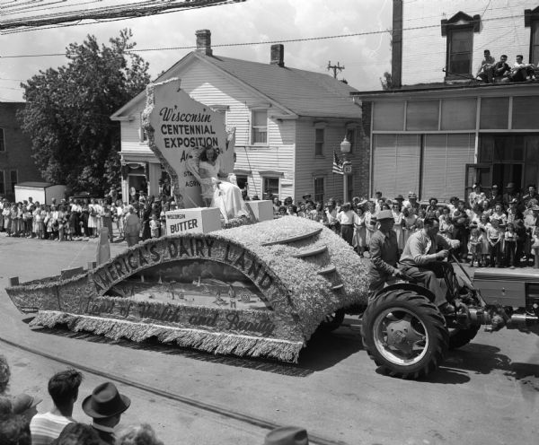 Wisconsin's first Alice in Dairyland, Margaret McGuire, riding on a float in a parade in her hometown.
