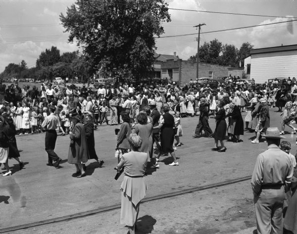 The crowd in the street at a parade honoring Margaret McGuire who was selected Wisconsin's first Alice in Dairyland.