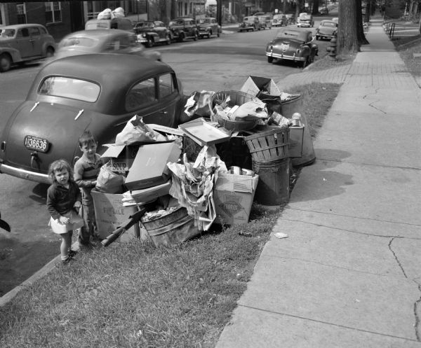 Uncollected garbage on South Hamilton Street being viewed by two children during a walkout strike by Local 236 Municipal Garage Department Union.