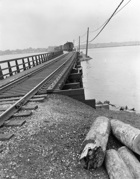 Chicago Northwestern Railroad tracks and train crossing Monona Bay, the site of an accident in which Harry R. Frankey, 112 South Henry Street, was killed in a fall from a moving Chicago Northwestern freight train. Mr. Frankey was trying to climb aboard the train when he fell.