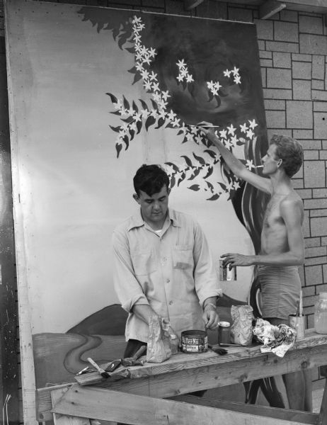 Edwin Morgan, at bench, and James Price, shirtless with cigarette in his mouth, are painting scenery for the Crater Players production of "The Drunkard".