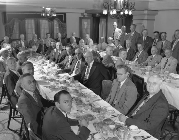 Members of the Illinois Commercial Men's Association seated at banquet tables.