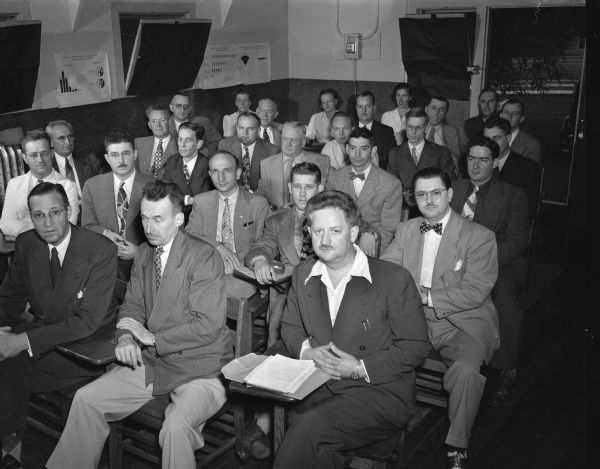 Wisconsin physicians seated in a classroom while attending the second annual polio short course. The course is co-sponsored by the Wisconsin Medical School and the Wisconsin county chapters of the National Foundation for Infantile Paralysis.
