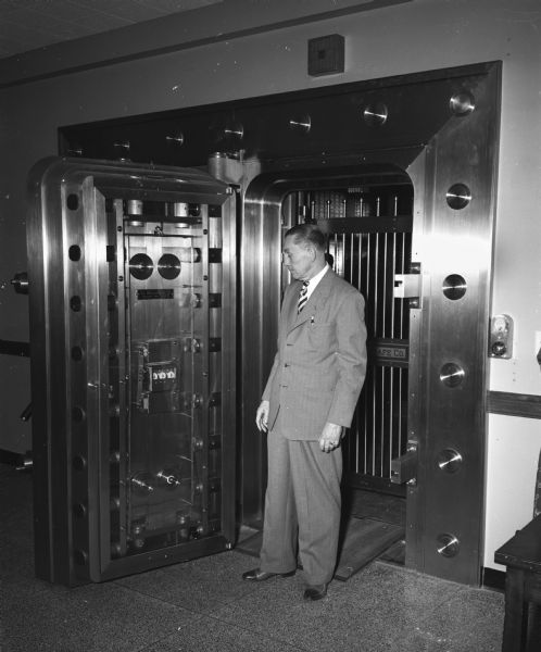 Alf Peterson, vice president of Security State Bank, standing at the open door of the bank's new vault at 1965 Atwood Avenue.