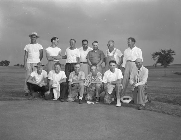 Flight champions of the annual East Central Golf Association Tournament held at the Stoughton Country Club. First row, left to right, are Jack Astell, Jefferson; Frank Rhyme, Portage; Carl Christianson, Cambridge; Phil Schoenbeck, Cambridge, junior champion; Clyde Knudson, Stoughton; and Seth Adolphson, senior and first flight winner. Second row, left to right, are Fred Ifferman, Lake Mills; Don Taylor, Portage; Charles Tracy, Edgerton; John Roethe, Edgerton; and Jack Rowland, Stoughton.