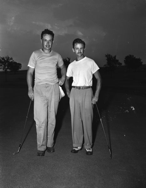 Champion Gilbert "Gib" Bergdoll (right) of the Koshkonong Mounds Club of Fort Atkinson and runnerup, Norbert "Coley" Griffin of Meadow Springs Club of Jefferson after the East Central Golf Association Tournament held at the Stoughton Country Club.