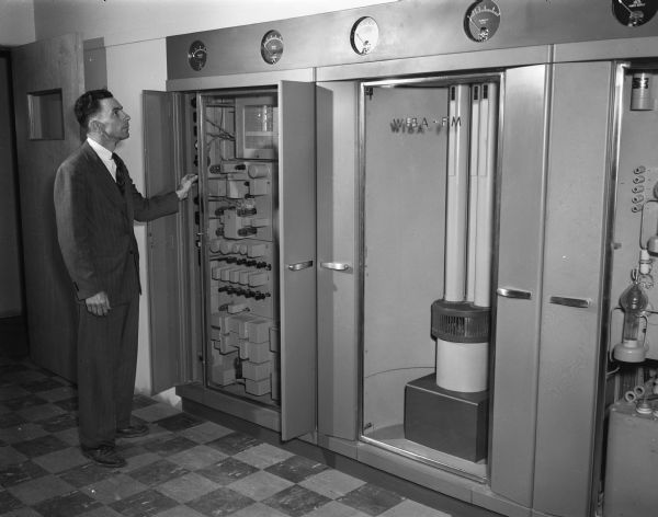 Norman Hahn, chief engineer for WIBA and WIBA-FM, is shown at one section of the 10,000 watt transmitter.