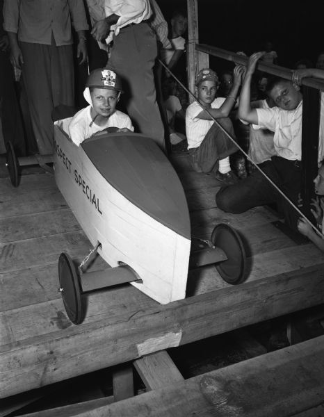 The 1948 runner-up of the Soap Box Derby is Tommy Smrekar, son of Mr. and Mrs. Michael Smrekar, Ft. Atkinson. He is shown sitting in his racer, "The Prospect Special."