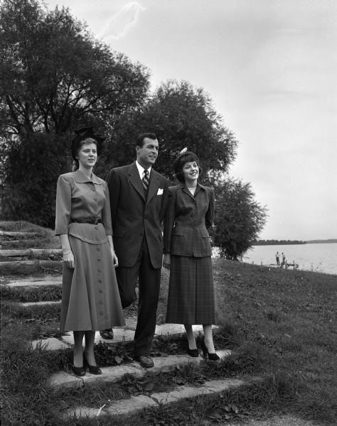 Three of the models who will appear in the annual summer session style show, sponsored by the Women's Self Government Association, are shown on the steps near the Memorial Union Terrace. They are, left to right: Audrey Kvam, Milwaukee; John Buckley, Cleveland, Ohio; and Merel Cayna, Chicago.
