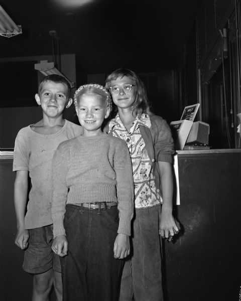 Portrait of three Proudfit Street kids who produced a circus for the benefit of the Ballweg family, victims of a tornado at Springfield Hill. They are, left to right, Ronnie Herrington, Genevieve Opheim, and Barbara Pertzborn.