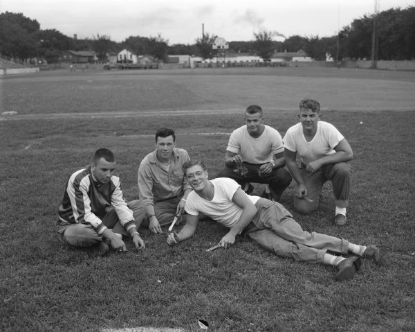 Five Madison city lifeguards that were assigned to prepare the Breese Stevens Field for the All Star high school football game. Left to right are: Glenn Wilcox, Wally Benson, "Buzz" Rebenstorff, Chuck Steele, and Rudy Miller, Jr.