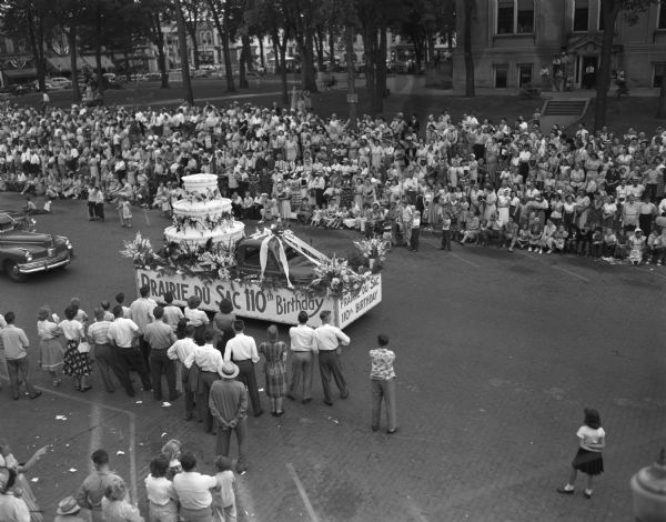 Prairie du Sac's 110th birthday float in Sauk County's Wisconsin Centennial Parade in downtown near park.