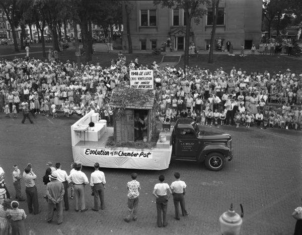 L.C. Welsh Plumbing float entitled "Evolution of the Chamber Pot" in Sauk County's Wisconsin Centennial Parade.
