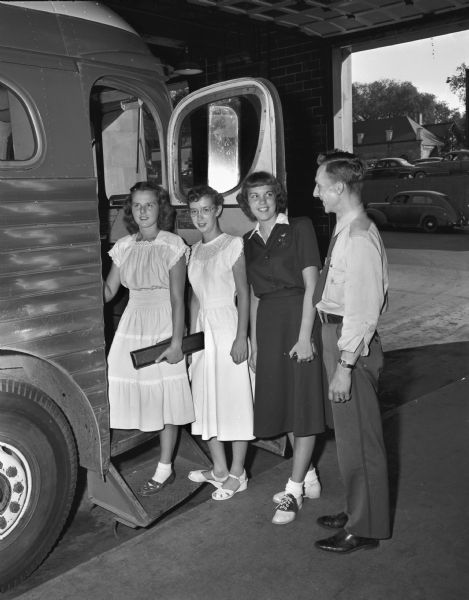 Preparing to board a bus to attend the Wisconsin Centennial in Milwaukee are left to right: Ann Seibold, West High School orchestra, Beth Mitchell, all-state band, and Norma Trindle, Girl Scouts, and Nathan Larson, of the Greyhound Bus Company.