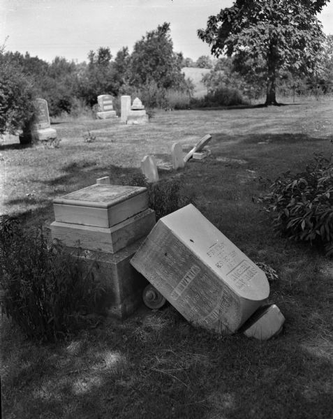 Vandalized tombstone following a beer party held in Evergreen Hill Cemetery on June 12.