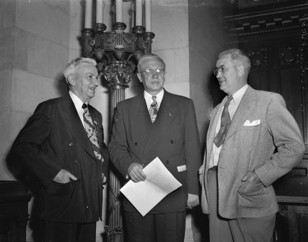 Governor Oscar Rennebohm greeting two Elks convention delegates. They are (left) Charles E. Broughton, Sheboygan, past national grand exalted ruler, and Dr. A.V. Delmore, Two Rivers, past Wisconsin president.