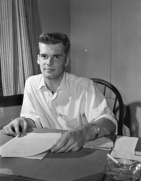 Richard John, President, University of Wisconsin Student Board, sitting at a desk.