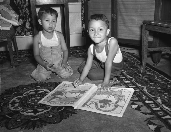 Sherif, 4, and Mohammed, El Gindi, 5, sitting on an Oriental rug brought from Egypt by their parents. Their father, Ibrahim, was chosen by the Egyptian government to do graduate work in biochemistry at the University of Wisconsin.